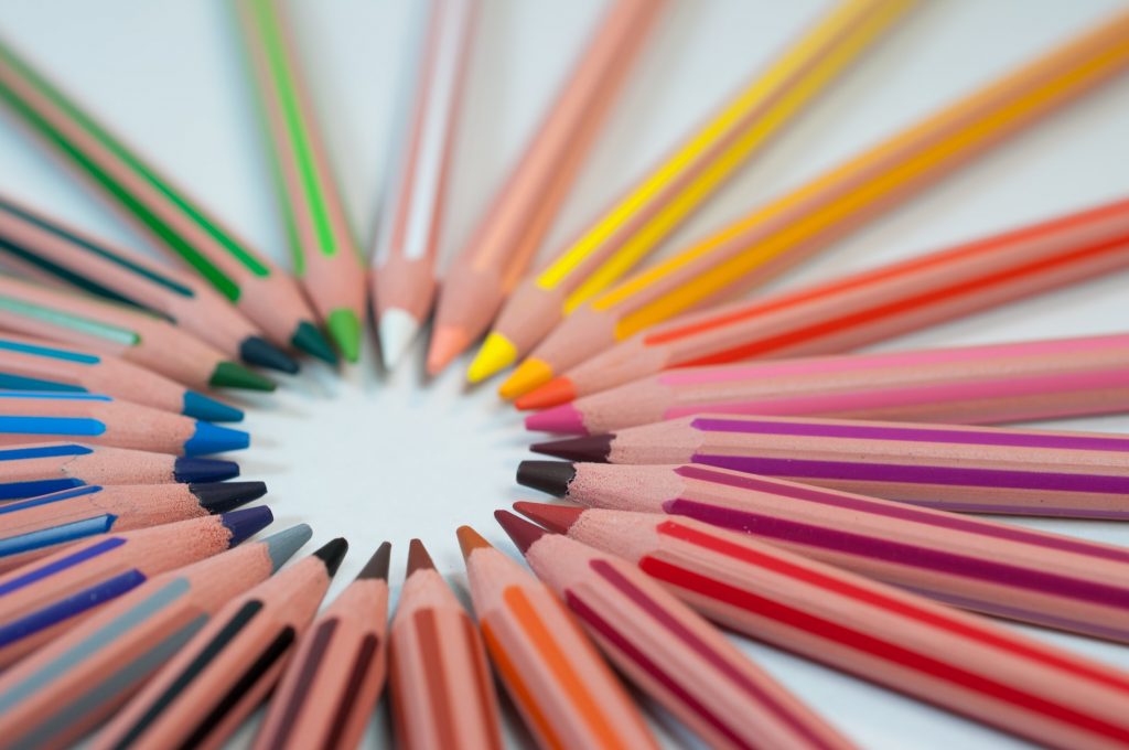 Coming up with article ideas. Photo of a circle of colored pencils. Photo credit: Agency Olloweb, via Unsplash. 