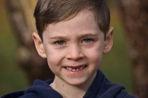First grade photo shoot: Close up of a first grade boy with his front teeth missing | photo by Jennifer Margulis