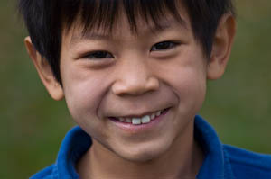 Close up of a first grade Asian American boy during a first grade photo shoot | photo by Jennifer Margulis