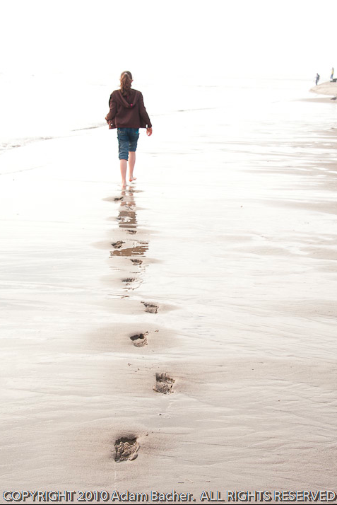 A young girl walking along the beach in the Taft District of Lincoln City, Oregon. 