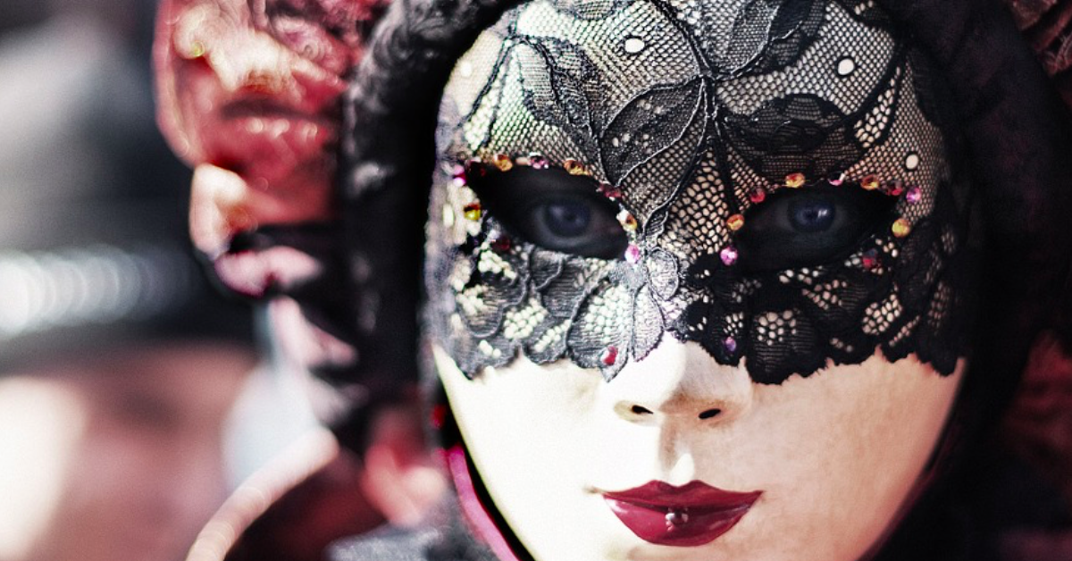 Writers experience imposter syndrome. A photo of a masked person at a carnival. Via Jennifer Margulis, Ph.D.