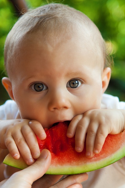How do you encourage your family to become healthy eaters? Jennifer Margulis has great tips. Photo of a baby eating some watermelon.