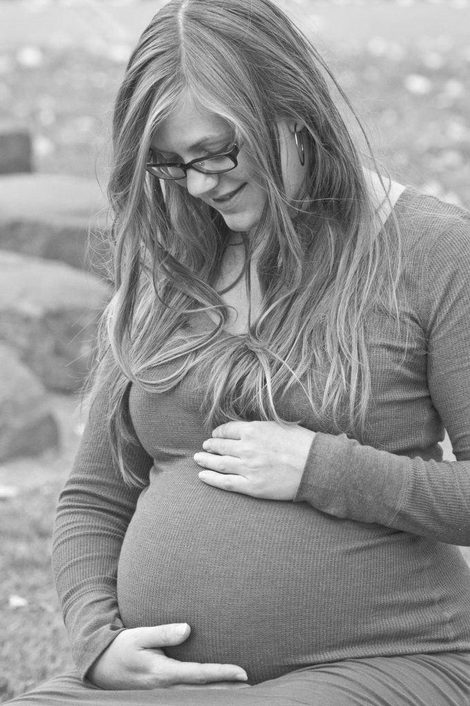 Looking like you swallowed a watermelon is one of the many signs of pregnancy. But before you start to show, you may not be so sure. Black and white photo of a pregnant woman by Jennifer Margulis