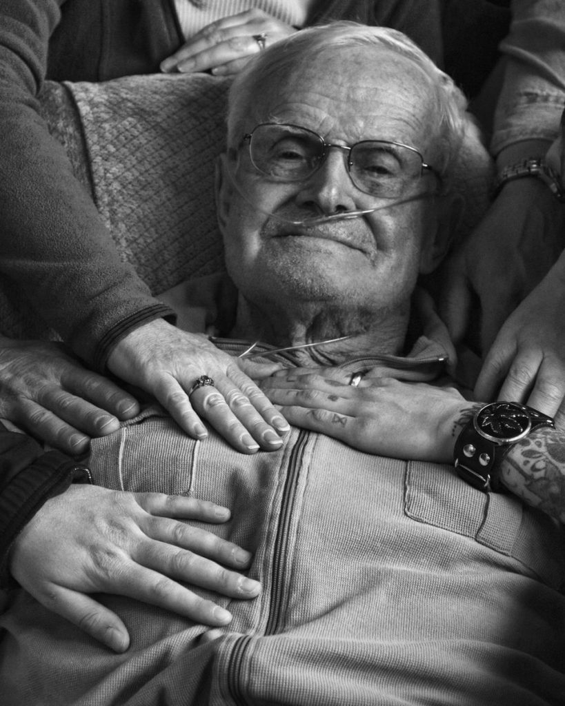 We all want a death with dignity. But how do we make sure that's what happens? A dying man is surrounded by loved ones. Photo courtesy of Mary Landberg.