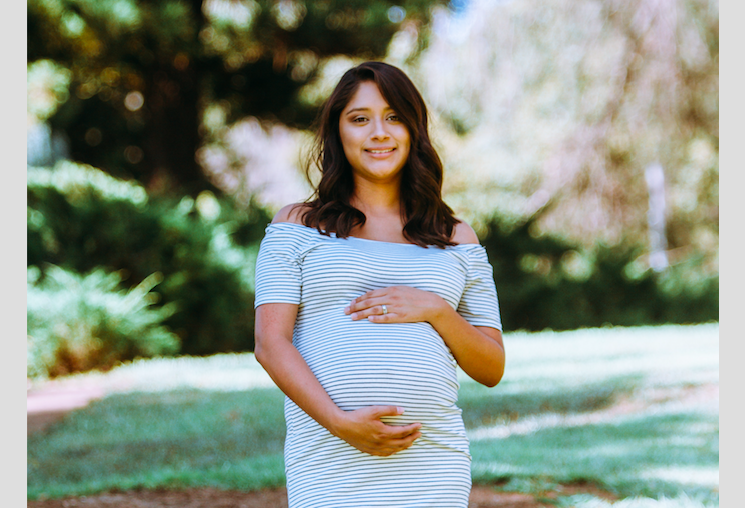 Photo of pregnant woman in a striped dress by Omar Lopez. Everything's for sale, even your positive pregnancy test.
