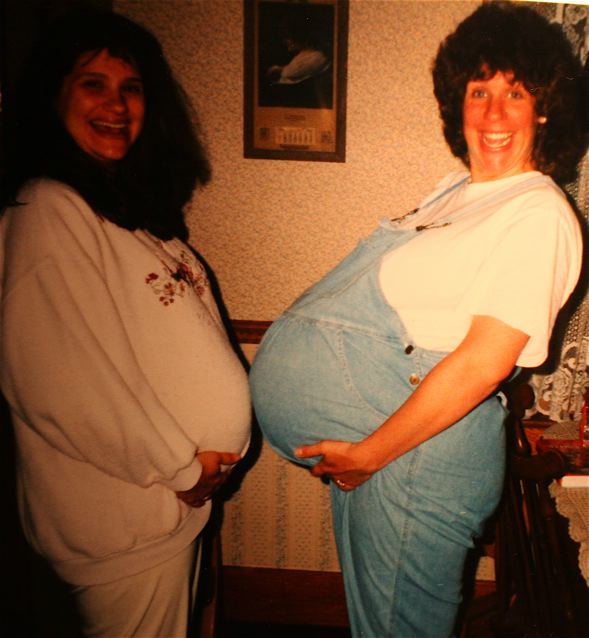 Two awesomely happy pregnant ladies. Who says it's not fun to be as big as a brick house?! Pregnancy and childbirth are hilarious. Photo courtesy of Karen Driscoll.