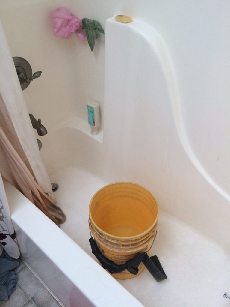 The bucket in our bathroom catches gray water from the shower which we then use to water the plants. Via Jennifer Margulis, Ph.D.