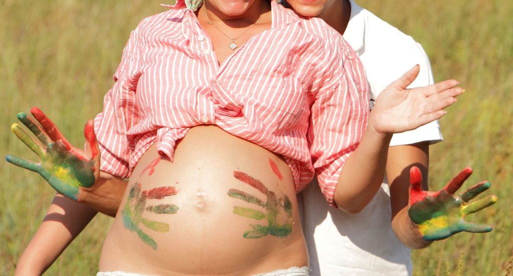 Doctors need to stop bullying pregnant women. Pregnancy is a state of good health and happiness, not a disaster waiting to happen (photo of a pregnant woman doing art on her belly courtesy of Pixabay)