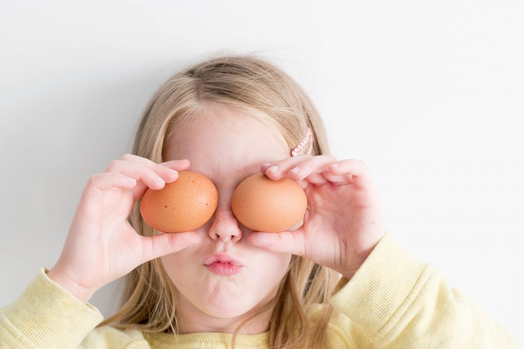 Love to cook 2. Photo of a little girl holding eggs courtesy of Hannah Tasker via Unsplash.