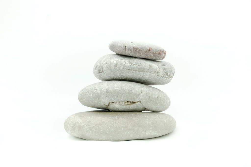 Excellent advice on how to meditate. Photo of four rocks piled up on a white background via Pixabay. | Jennifer Margulis