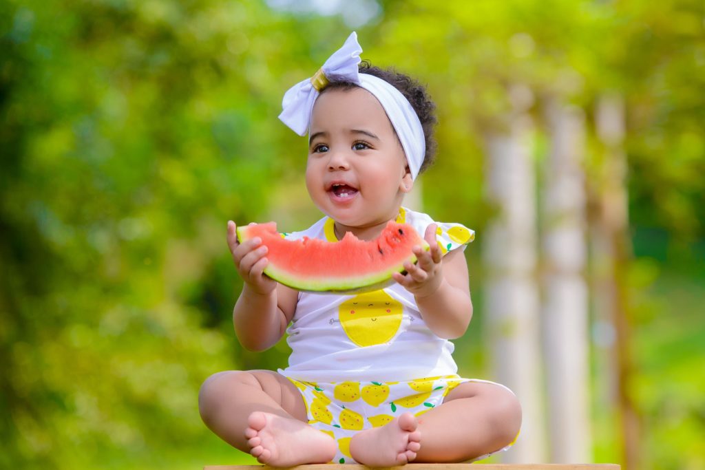 New study compares health outcomes in vaccinated and unvaccinated children. Photo of a baby in nature eating a slice of watermelon courtesy of Dazzle Jam via Pexels. | Jennifer Margulis, Ph.D.
