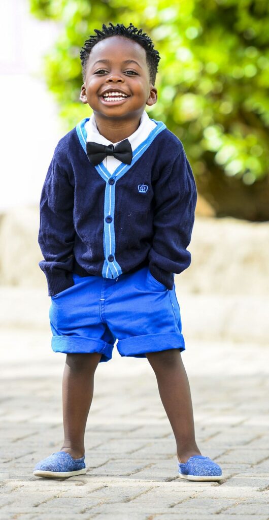 The COVID-19 vaccine for 5 year olds has been approved. Photo of a smiling African American boy in blue shorts by Terricks Noah via Unsplash | Jennifer Margulis, Ph.D.